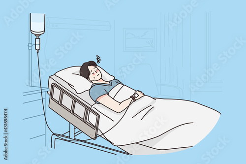 Healthcare and medicine concept. Sick sad unhappy young man cartoon character attached to intravenous drip lying on bed in hospital room feeling depressed vector illustration 