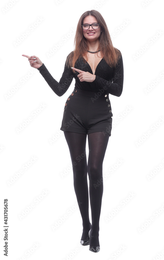 elegant young woman pointing at a white blank screen . elegant young woman pointing at a white blank screen .