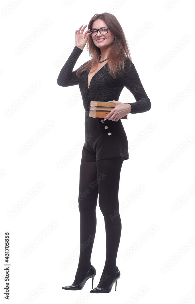 smiling young woman with a stack of books striding forward . smiling young woman with a stack of books striding forward .