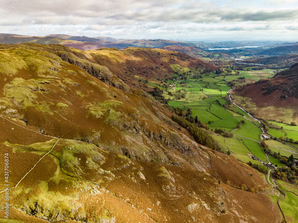 Aerial sunset view of the Lake District, famous for its glacial ribbon lakes and rugged mountains. Popular vacation destination in Cumbria, North West England.