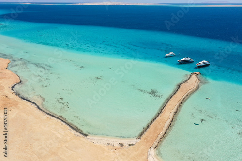 Aerial view: Beautiful sandy lagoon in the Red Sea and three yachts, Egypt