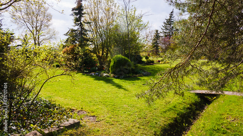 Foto Backyard ornamental garden in the countryside in spring, on the right side of th
