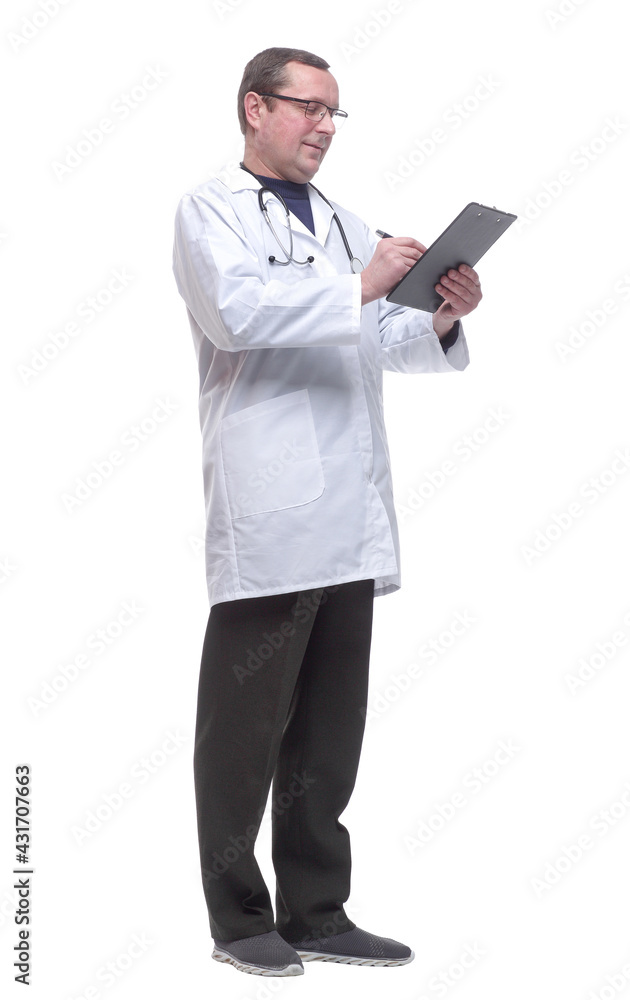 in full growth. doctor with a stethoscope taking notes in the clipboard. in full growth. doctor with a stethoscope taking notes in the clipboard.