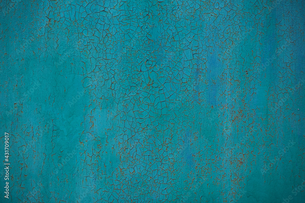 Old cracked blue-green paint on metal background