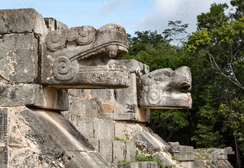 Snake head sculptures at the plaform of eagles and jaguars, Chichen-Itza, Yucatan, Mexico photo
