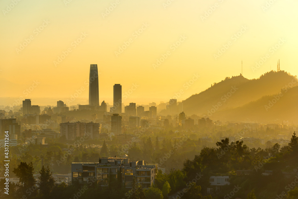A silhouetted panoramic view of Santiago de Chile at sunset.