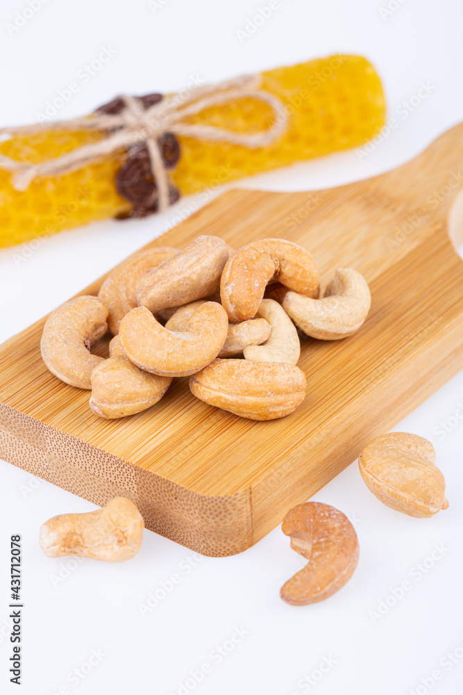 Fototapeta premium cashew nuts, fried, large, on a wooden board, on a white background