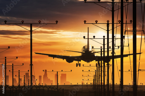 Plane landing in LAX airport at sunset. Los Angeles, California