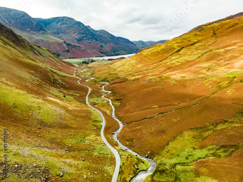 Cuadro en lienzo Aerial view of Honister Pass, a mountain pass with a road winding along Gatesgarthdale Beck mountain stream