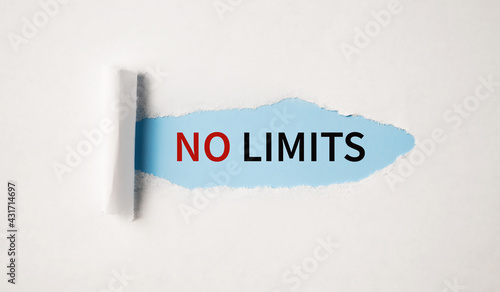 NO LIMITS message written under torn paper on blue background.