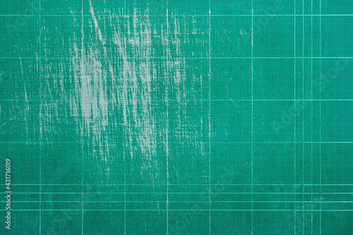 Old grunge green dirty cutting mat, grunge texture background,  top view, copy space for text and graphic.