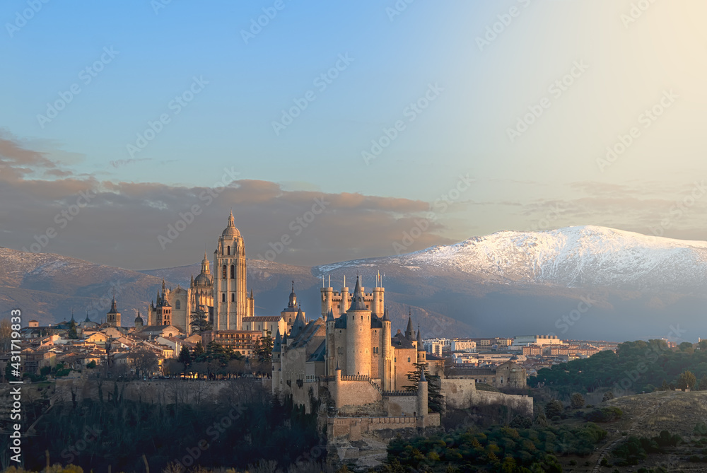 Sunset panorama of the old city of Segovia with the snowy Navacerrada in the background