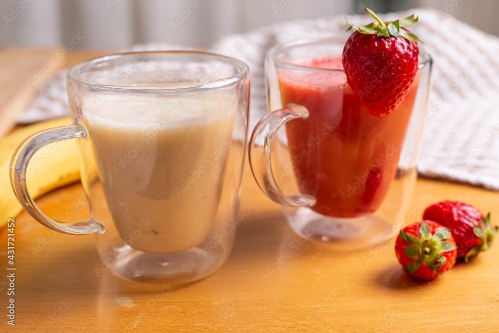 Strawberry and banana smoothie in glass glasses Strawberry and banana smoothie in glass glasses