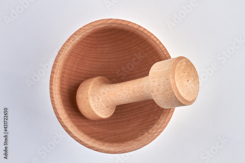 Top view of wooden mortar and pestle isolated on white background.