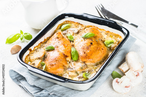 Baked chicken breast with mushrooms in cream sauce.