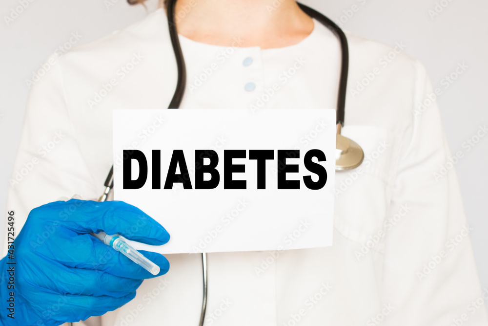 the doctor in gloves holds a card with the text DIABETES . white background. the medicine the doctor in gloves holds a card with the text DIABETES . white background. the medicine