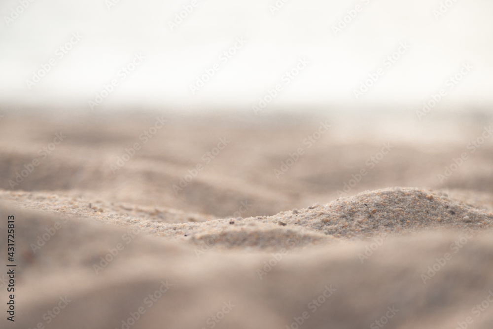 Zoom in to sand texture on the beach, see small stone on there with