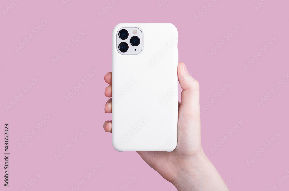 Female hand holding white iPhone 11 Pro in soft silicone white cover back view . Phone case mock up isolated on pink background , iPhone 12 Female hand holding white iPhone 11 Pro in soft silicone white cover back view . Phone case mock up isolated on pink background , iPhone 12