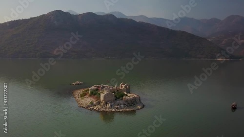 Aerial view around a old prison ruins on Grmozur island, at Lake Skadar, in Montenegro - orbit, drone shot photo