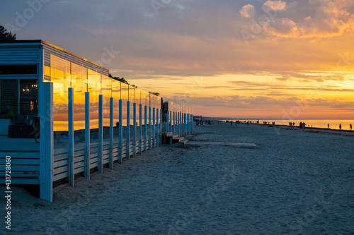 Cafe on beach during sunset. Beautiful colorful clouds over Baltic sea in Jurmala resort, Latvia. Relax, vacation concept. photo