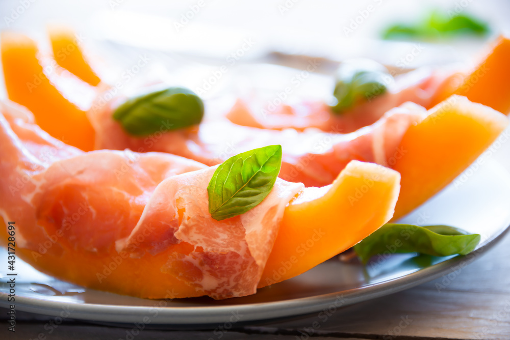 Fresh sweet melon with prosciutto ham, healthy summer food
