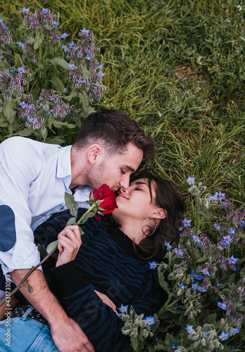 Couple kissing with some flowers