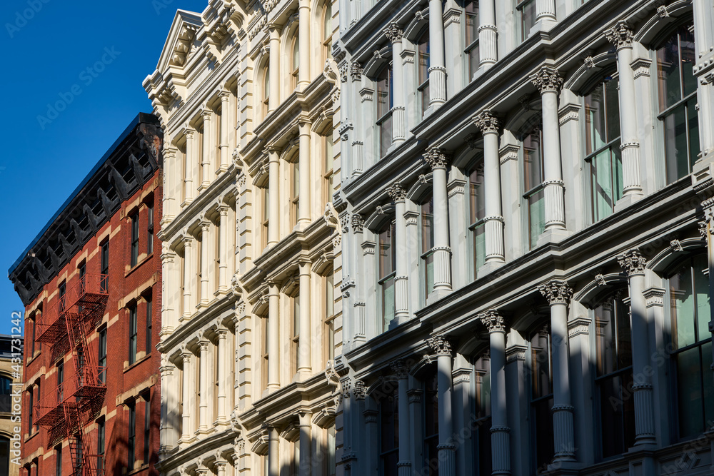 Typical building facades in SoHo, the Cast Iron Historic District with distinct late 19th centtury architecture. Manhattan, New York City, USA