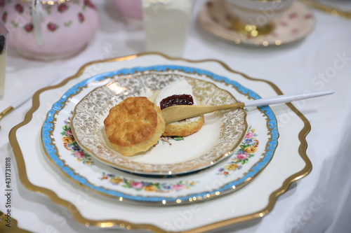 Fotografija Table set up for tea party, focus on cake with jam on the vintage plate