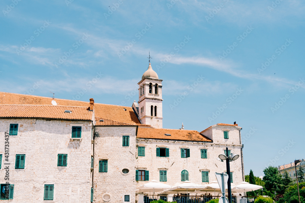 Franciscan monastery Sveti Frane, Sibenik, Dalmatia, Croatia on the background of blue sky and greenery around