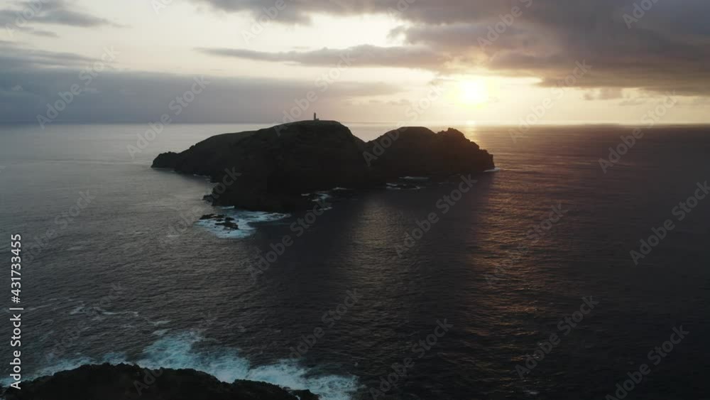 Stunning sunset creating silhouette of Ilhéu de Ferro, island of Porto Santo Stunning sunset creating silhouette of Ilhéu de Ferro, island of Porto Santo
