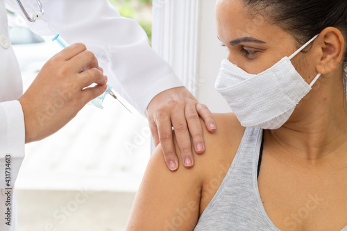 Fotografie Medical mask patient looking applying injection. Close up.