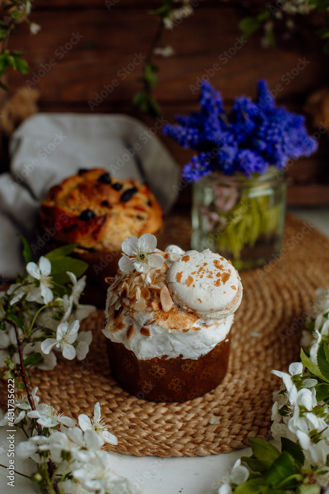 Easter cake decorated with white petals, nuts and macaroon. easter cupcake and blossoming apple tree branches Easter cake decorated with white petals, nuts and macaroon. easter cupcake and blossoming apple tree branches