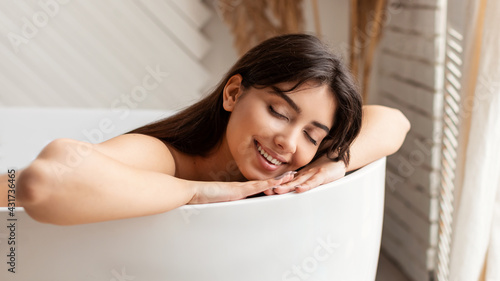 Happy Woman Bathing Lying With Eyes Closed Relaxing In Bathroom