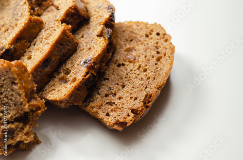 Freshly made spiced fruit loaf cake on the white background