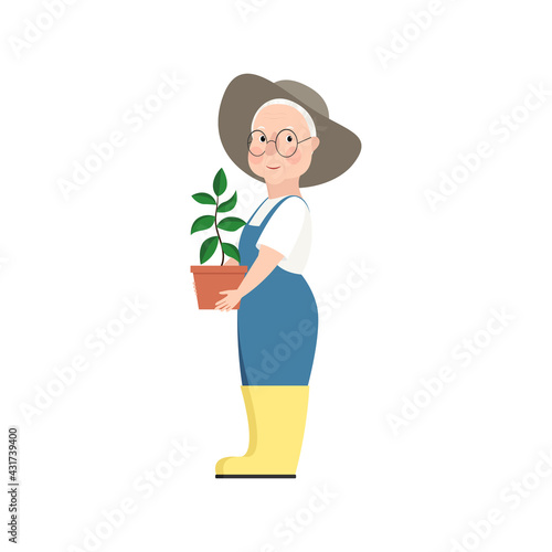 Cute old lady with wrinkled face and gray hair stands holding garden plant. Woman in overalls, rubber boots, glasses, and a hat. Vector stock hand-drawn illustration isolated on a white background