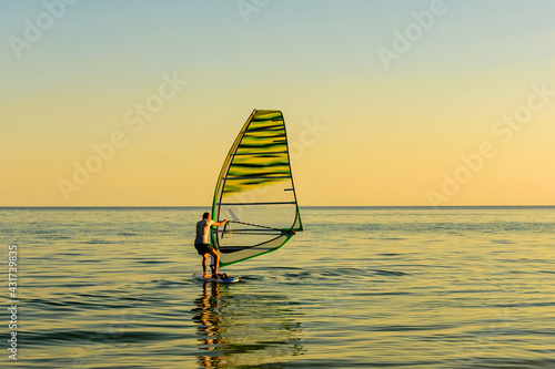 Male windsurfer training. Summer vacation at the seaside