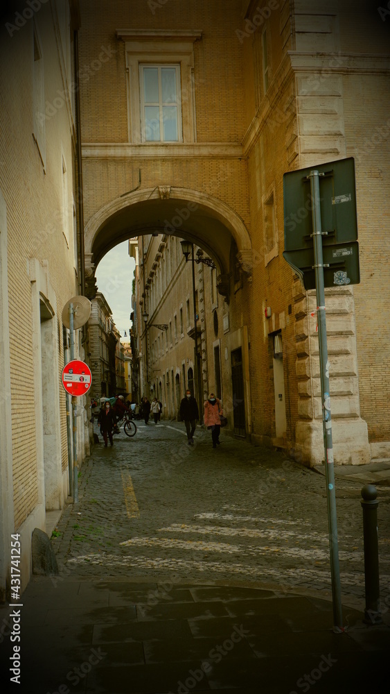 View of the Forum of Rome through an arch between two apartment buildings on the Campidoglio square in Rome View of the Forum of Rome through an arch between two apartment buildings on the Campidoglio square in Rome