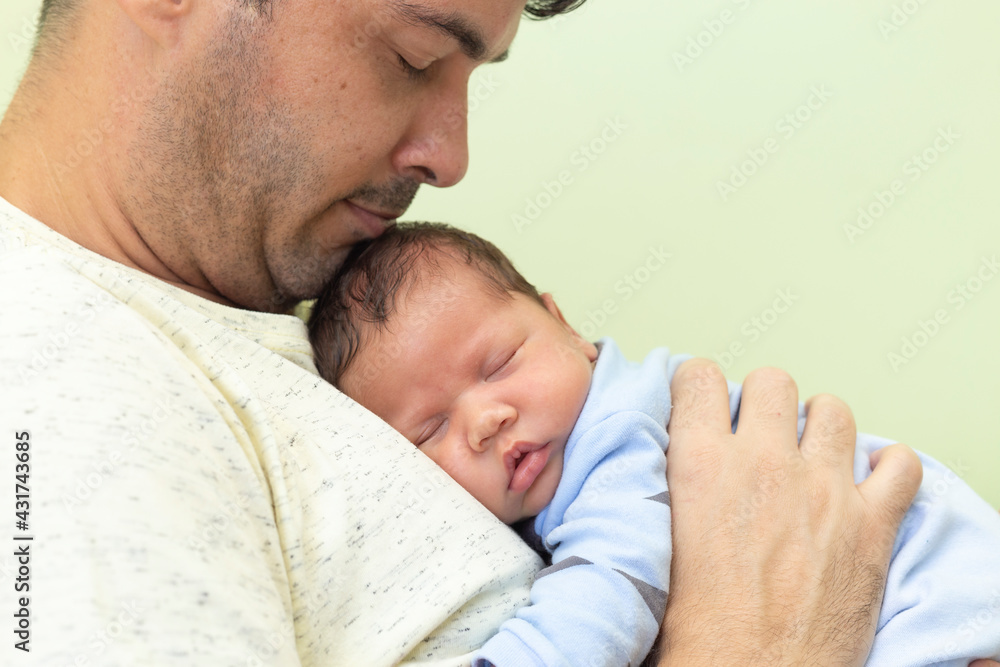 Man with baby sleeping on his lap. Man with baby sleeping on his lap.