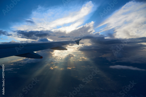 View from the window of an airplane sunbeams through the clouds. Colombia
