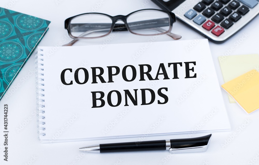 white notebook with words government bonds on the office table. Trading concept. white notebook with words government bonds on the office table. Trading concept.