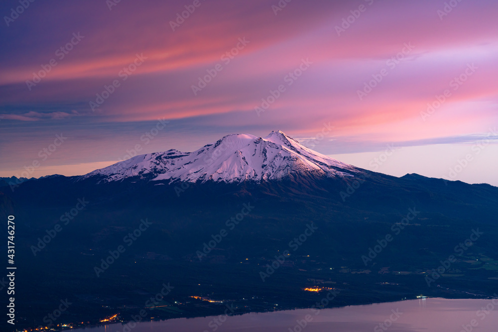 showing colors in the clouds and the snow top of calbuco volcano, after the sunset. blue hour