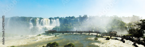Panoramic photograph of the Iguaçu Falls, showing a bridge where you can take people closer to the waters.