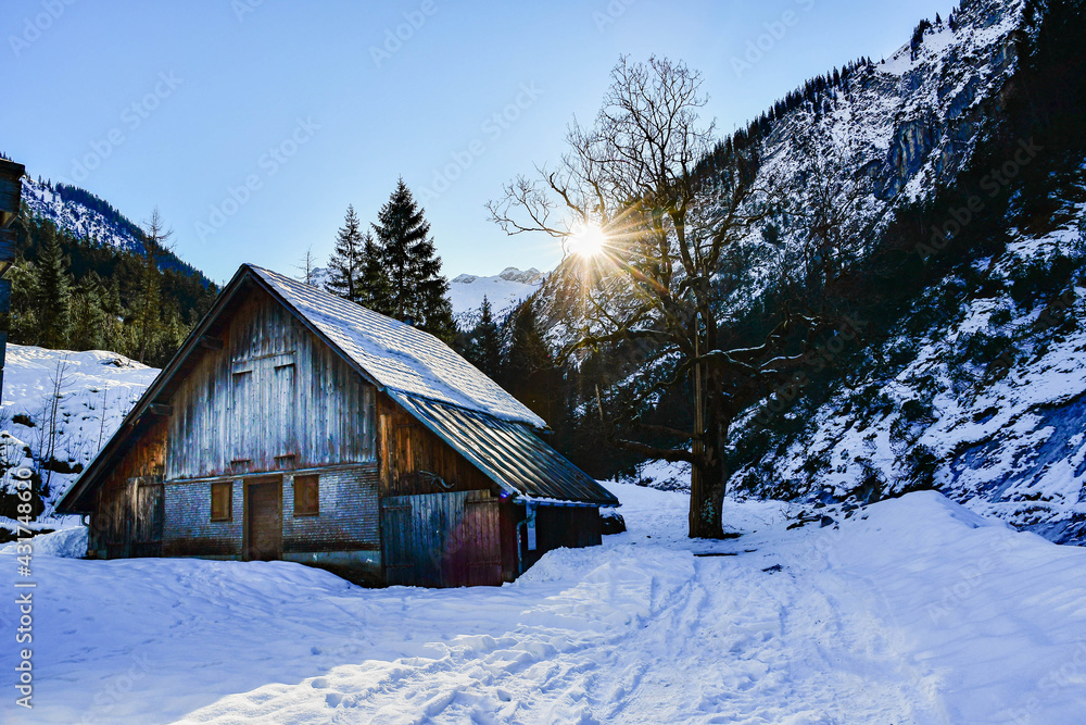 Wooden house in snow landscape