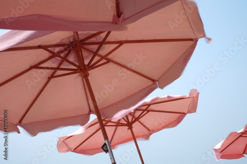 Pink umbrella contrast with blue sky