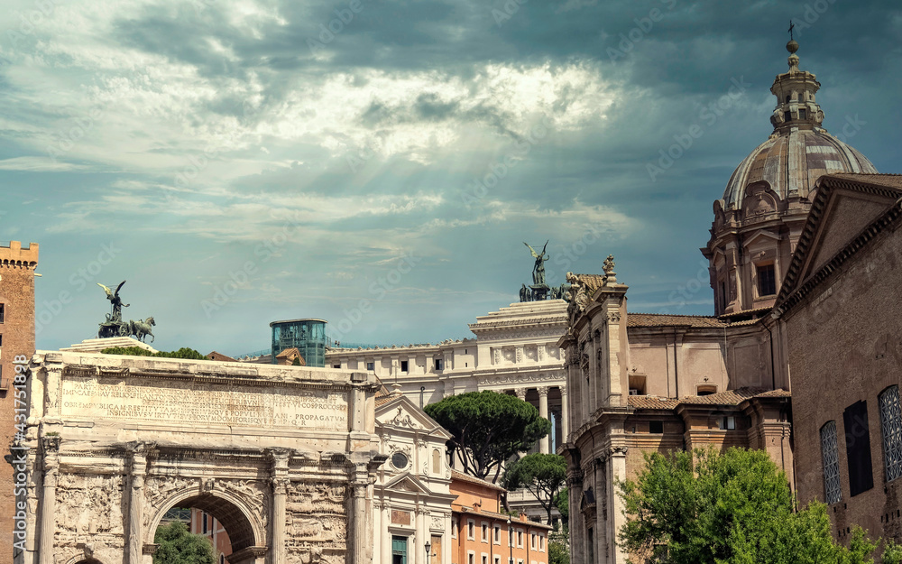Rome Italy, arch of Septimus Severus and Santa Martina in the Roman Forum under dramatic sky