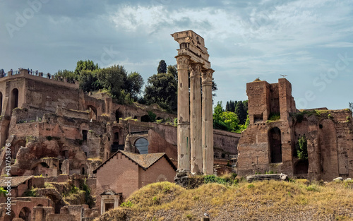 Rome, Italy, ruins of Dioscouri columns and Domus Tiberiana under a cloudy sky in the Roman Forum