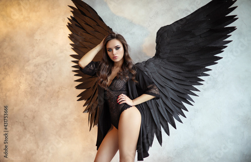 Fallen black angel with wings. Sexy woman