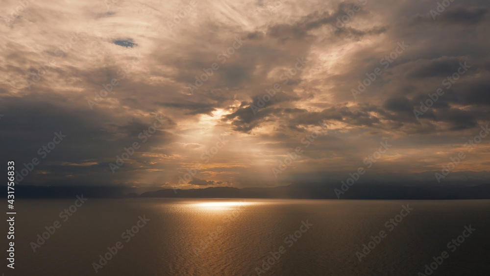 Beauty of colorful sky during the sunset from above. Beautiful sunset background from the colorful beams on the sky. Sunset over ocean. Seascape, Summer and travel vacation concept