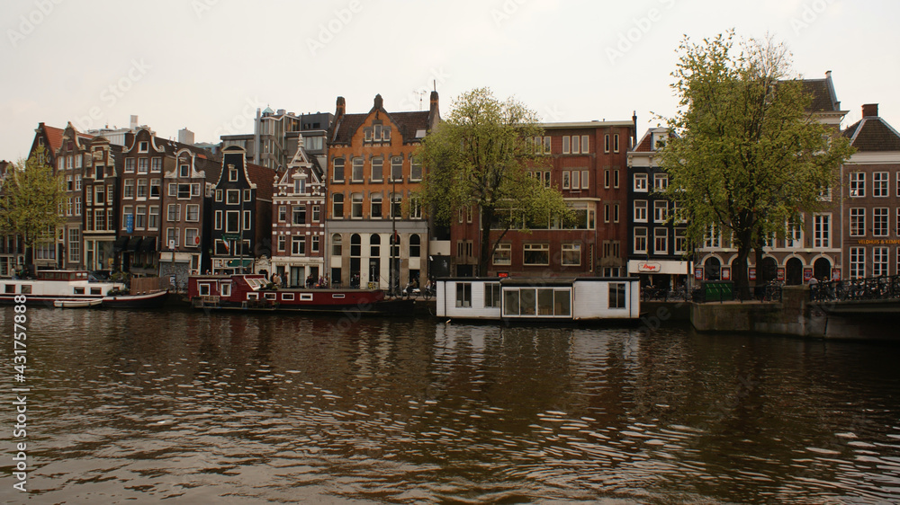 Amsterdam, Netherlands, April 2011: Cityscape from the sea, with home boats and the typical dutch buildings.