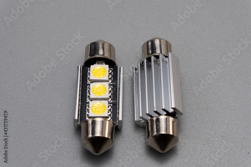 Car light bulb emitting diode, accessories and components for electronics vehicles. Modern technologies and low energy consumption concept. Gray background close-up view. 12V w5w photo